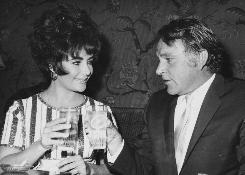 Actors and spouses Richard Burton and Elizabeth Taylor sharing a toast to celebrate her Best Actress Academy Award for the film 'Who's Afraid of Virginia Woolf?', 1966.
