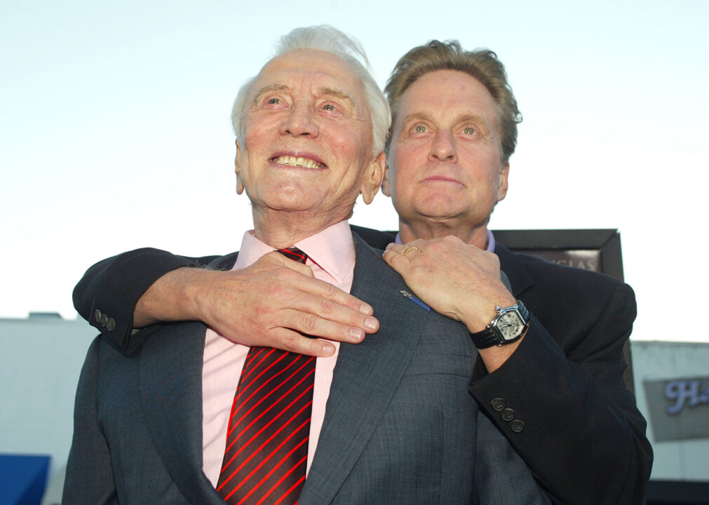LOS ANGELES - APRIL 7: Actor Kirk Douglas (L) and son producer/actor Michael Douglas arrive at the premiere of "It Runs In The Family" at the Bruin Theater on April 7, 2003 in Los Angeles, California.