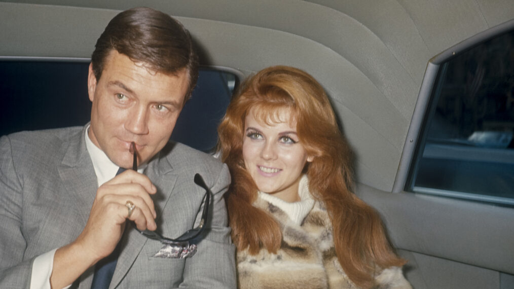Roger Smith with sun glasses and Ann-Margret in the back of a limo; circa 1970; New York.