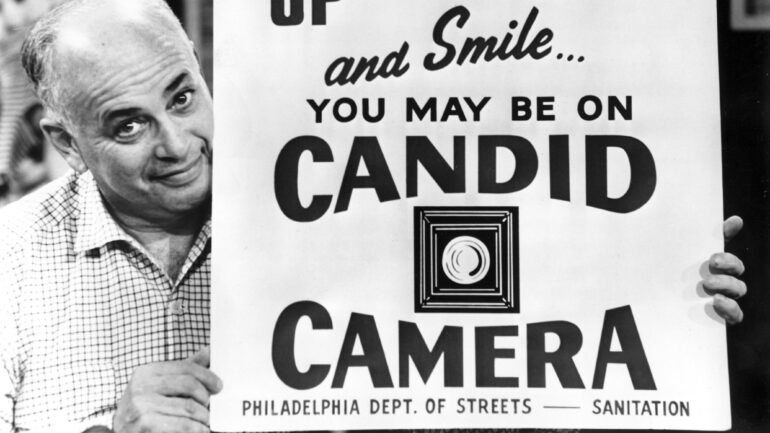 Allen Funt with Candid Camera sign, 1964