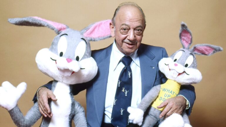 Mel Blanc surrounded with stuffed animals of Bugs Bunny that he did the voice for, 1983
