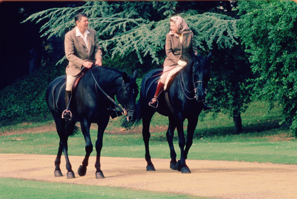 During a State Visit, US President Ronald Reagan (1911 - 2004) and British monarch Queen Elizabeth II ride horses together on the grounds of Windsor Castle, Windsor, England, June 8, 1982