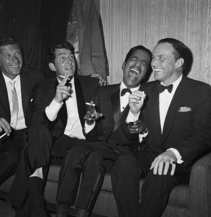 Jan Murray (L) sits alongside Rat Pack members Dean Martin, Sammy Davis Jr., and Frank Sinatra as the group unwinds backstage at Carnegie Hall after entertaining at a benefit performance in honor of Dr. Martin Luther King Jr.