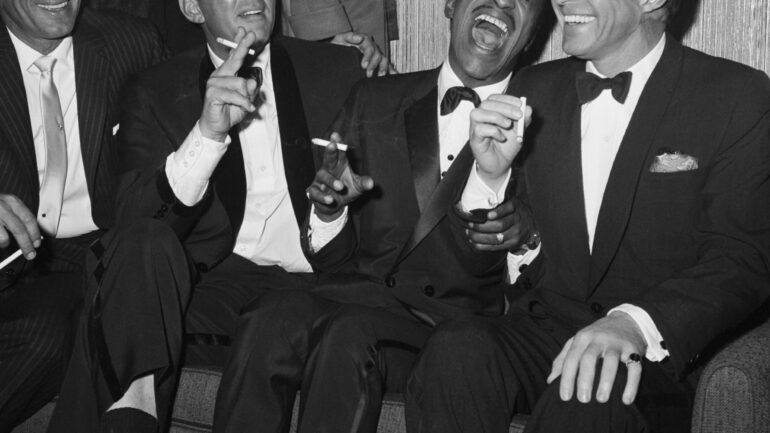 Jan Murray (L) sits alongside Rat Pack members Dean Martin, Sammy Davis Jr., and Frank Sinatra as the group unwinds backstage at Carnegie Hall after entertaining at a benefit performance in honor of Dr. Martin Luther King Jr.
