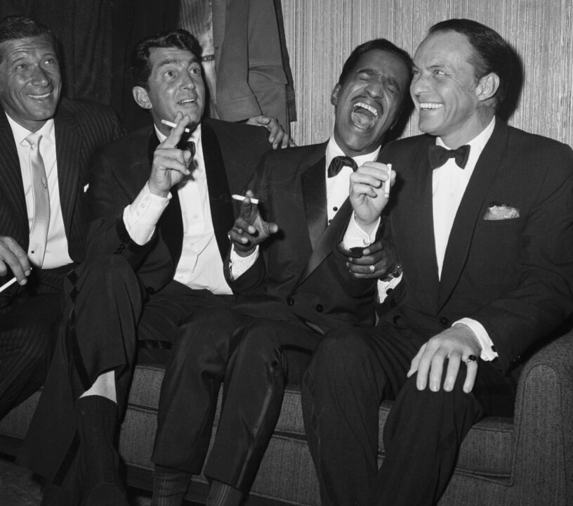 Jan Murray (L) sits alongside Rat Pack members Dean Martin, Sammy Davis Jr., and Frank Sinatra as the group unwinds backstage at Carnegie Hall after entertaining at a benefit performance in honor of Dr. Martin Luther King Jr.