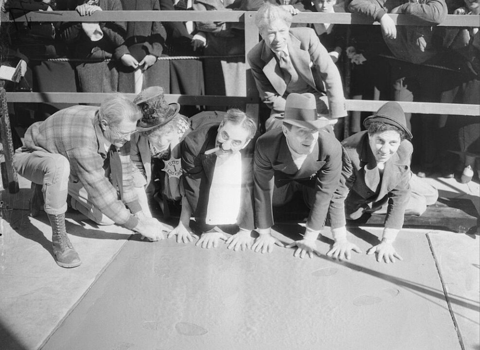 (Original Caption) X Marx the Spot. Hollywood, California: Caught hands down are the four Marx Brothers of film fame as they leave their fingerprints for posterity or something at Grauman's Chinese Theater in Hollywood, California. Left to right, Harpo, Groucho, Zeppo, and Chico Marx.
