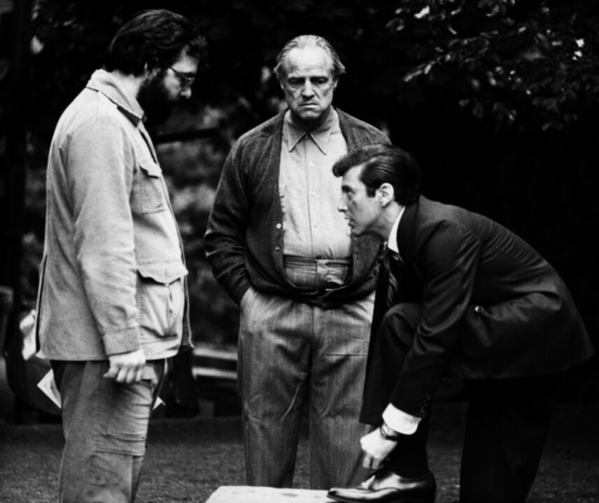 THE GODFATHER, from left: director Francis Ford Coppola, Marlon Brando, Al Pacino, on set, 1972
