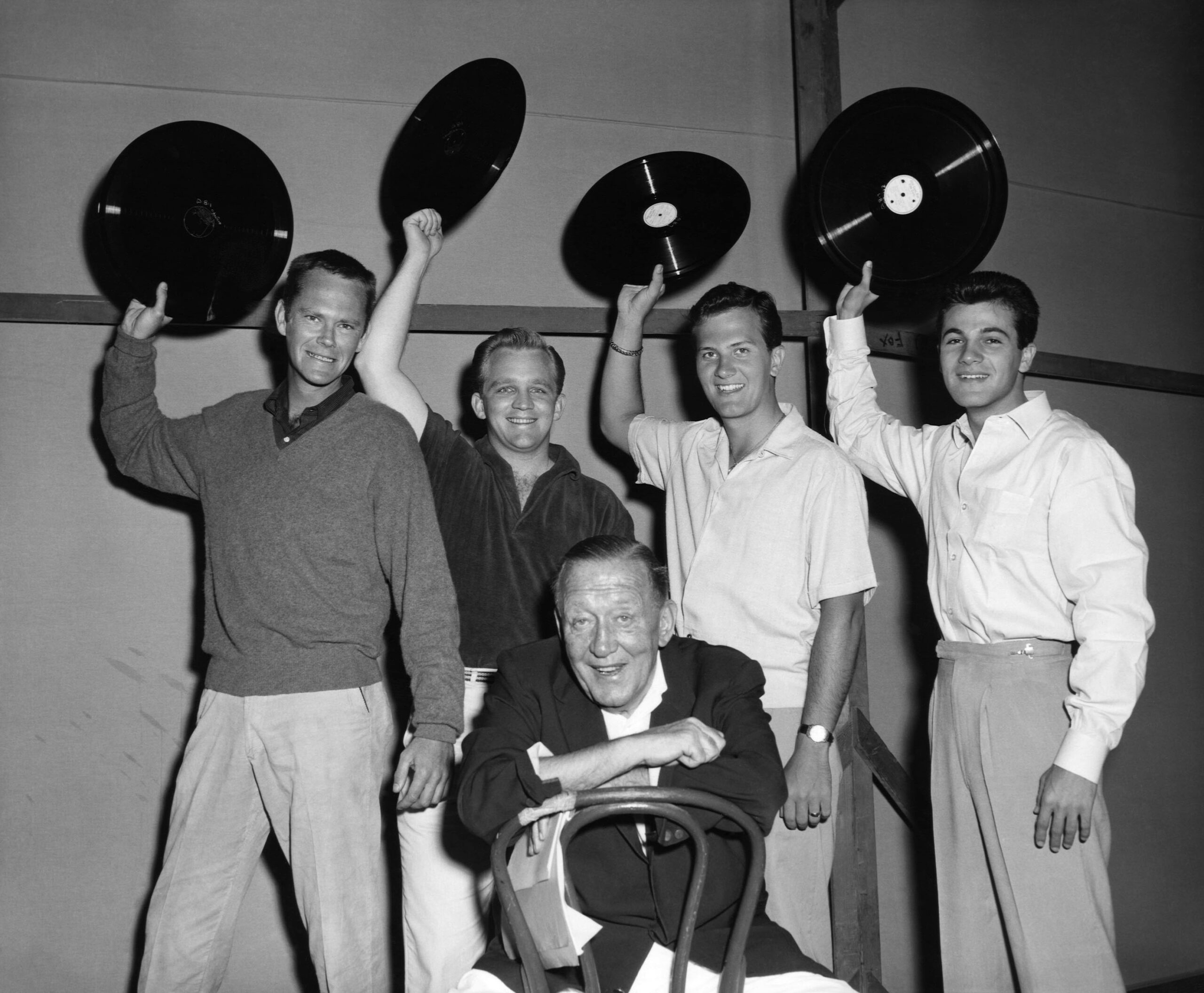 MARDI GRAS, Dick Sargent, Gary Crosby, Pat Boone, Tommy Sands, wave their recordings above director Edmund Goulding, 1958