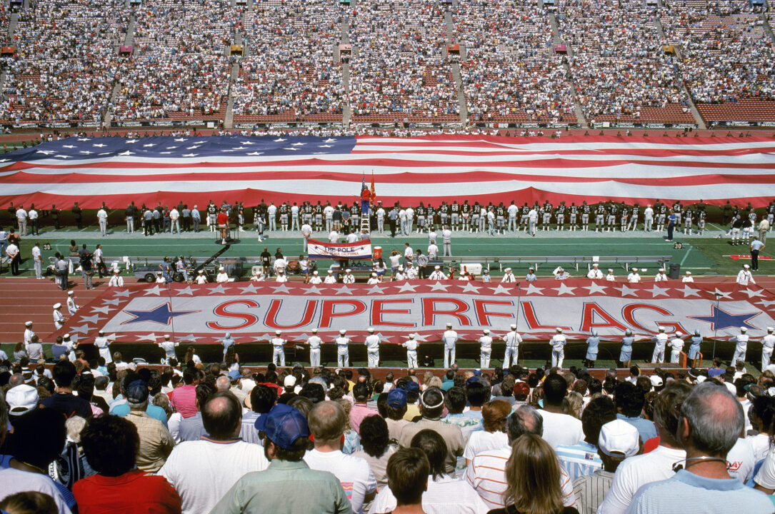 LOS ANGELES - SEPTEMBER 20: A giant flag is display on the field during the National Anthem before a game with the Detroit Lions against the Los Angeles Raiders at Los Angeles Memorial Coliseum on September 20, 1987 in Los Angeles, California. The Raiders won 27 -7.