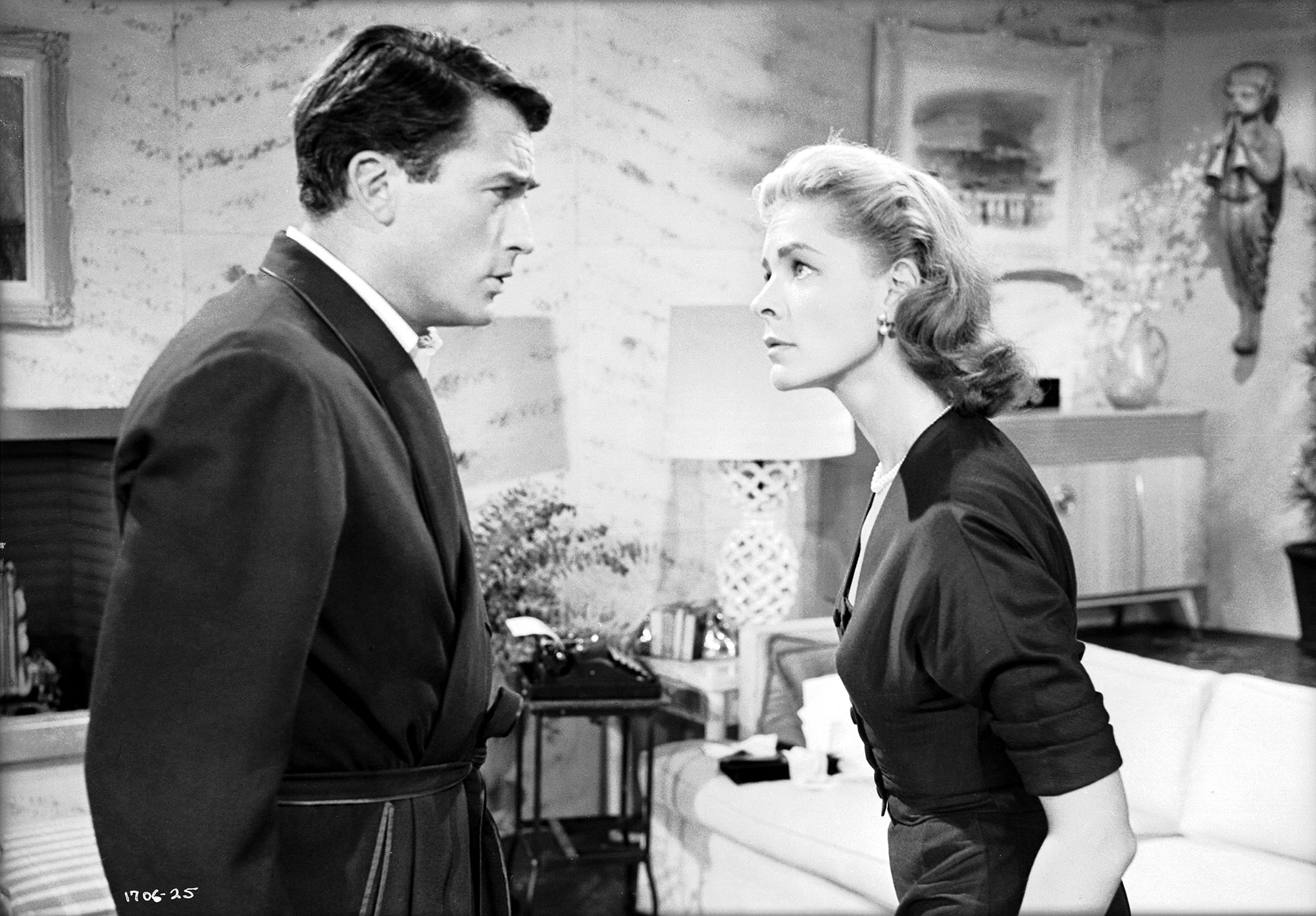Medium black and white shot of Gregory Peck, on left, as Mike Hagen facing Lauren Bacall, on right asMarilla Hagen in the 1957 movie "Designing Woman"