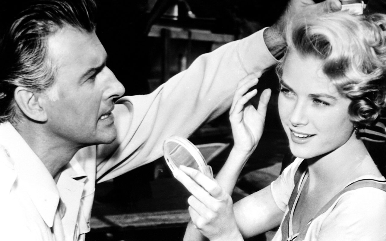 GREEN FIRE, Stewart Granger, helping Grace Kelly with her hair, on location in Colombia, 1954