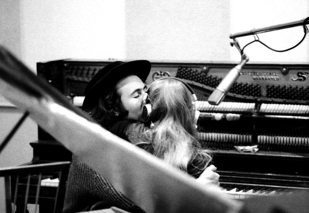 Musician Joni Mitchell gets a smooch from her beau and producer David Crosby while recording her first album "Song to a Seagull" at Sunset Sound Recorders in 1967 in Los Angeles, California.