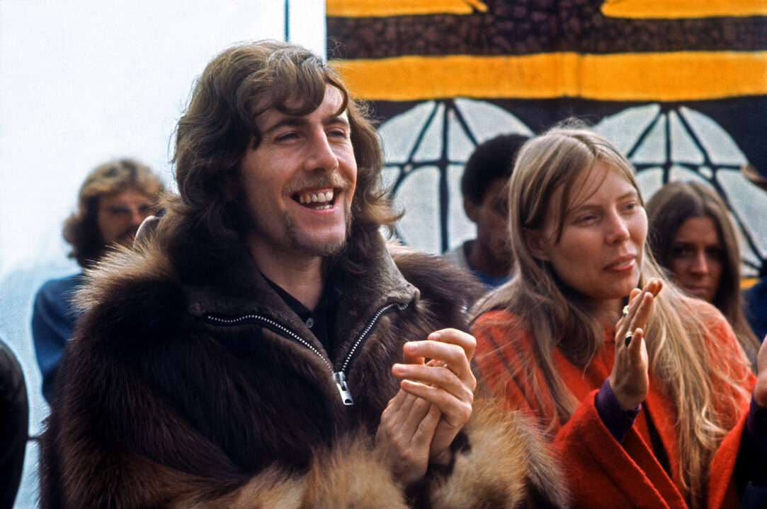 BIG SUR, CA - SEPTEMBER 14-15: Graham Nash and Joni Mitchell clap during an act at the Big Sur Folk Festival at the Esalen Institue on September 14-15, 1969 in Big Sur, California.