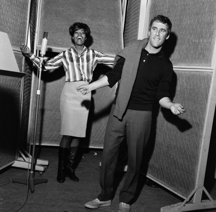 Burt Bacharach and Dionne Warwick recording a song at the Pye studios in London. Dionne sings and Burt directs and dances to the tune. 29th November 1964. (