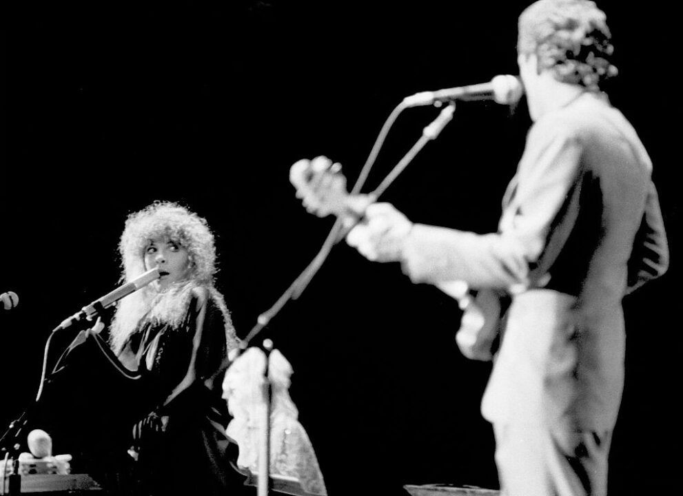 American musicians Stevie Nicks of the group Fleetwood Mac performs onstage at the Los Angeles Forum, Inglewood, California, December 6, 1979. In the foreground is American musician Lindsey Buckingham