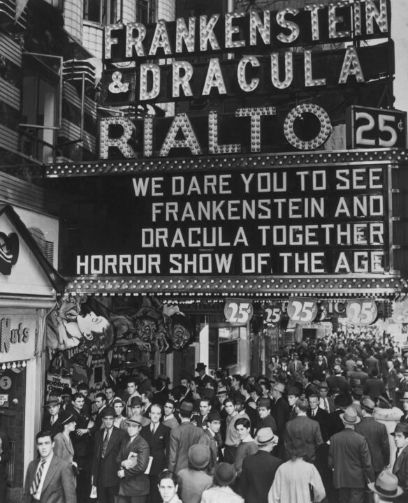 Crowds outside the Old Rialto Theater on Broadway, New York City, circa 1940. The Rialto is showing a horror double bill of Tod Browning's 'Dracula' and James Whale's 'Frankenstein', advertising it with a sign reading 'We dare you to see Frankenstein and Dracula together. Horror show of the age.'