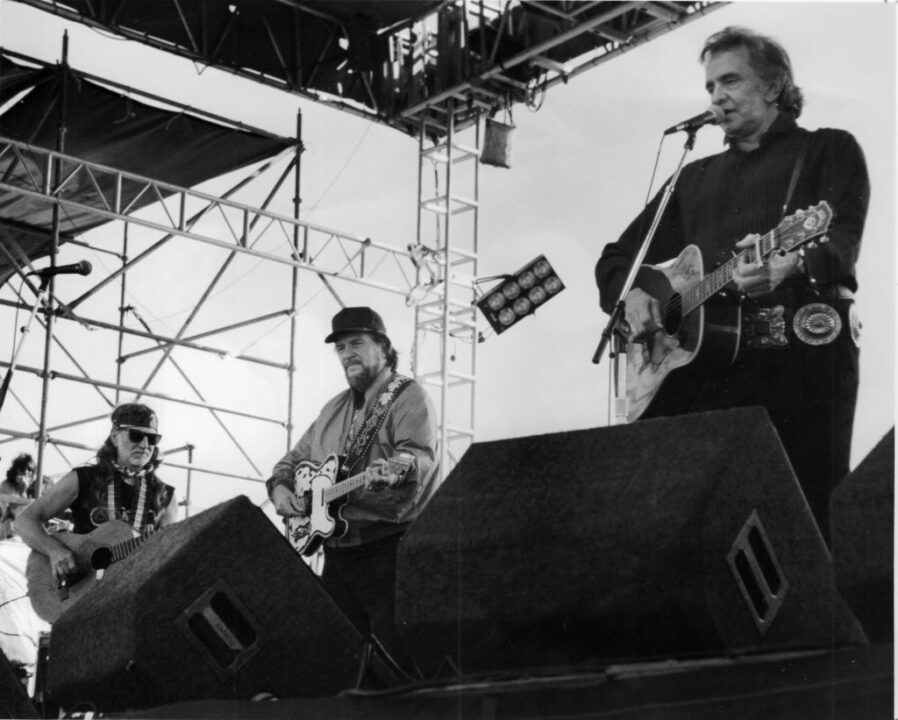 Montauk, N.Y.: Willie Nelson (left), Waylon Jennings (center) and Johnny Cash (right), perform at the Paul Simon benefit concert in Montauk on August 24, 1992. They are three out of the four "Highwaymen" who performed at the concert;Kris Kristofferson is not pictured