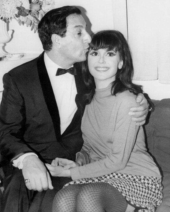 (Original Caption) Comedian Danny Thomas gives a congratulatory kiss to his young daughter, Marlo, backstage at a Piccadilly theater here November 25th. Marlo is appearing in the London production of the Broadway hit Barefoot in the Park.
