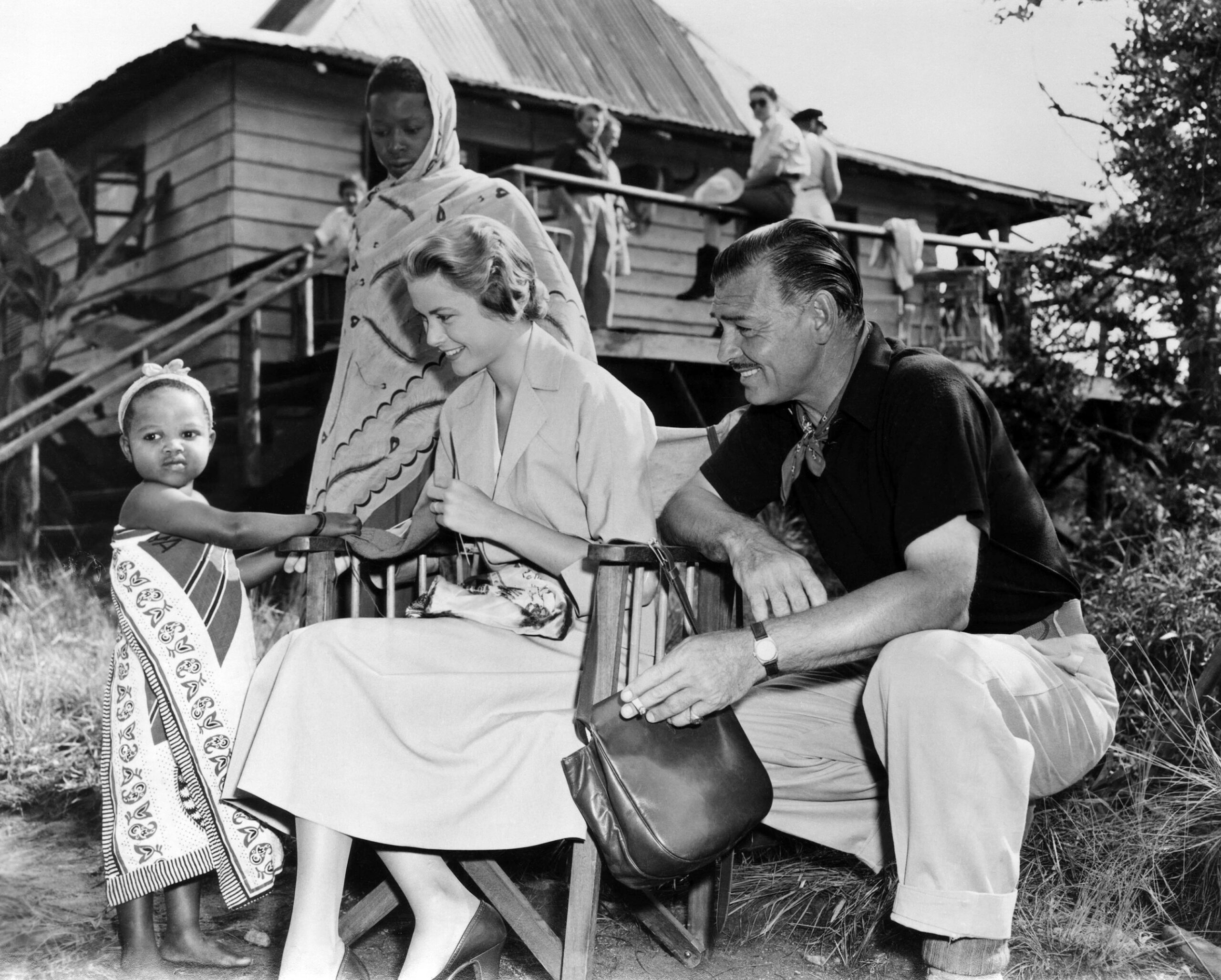MOGAMBO, from left, Grace Kelly, Clark Gable mingling with the natives on location in Tanganyika, 1953