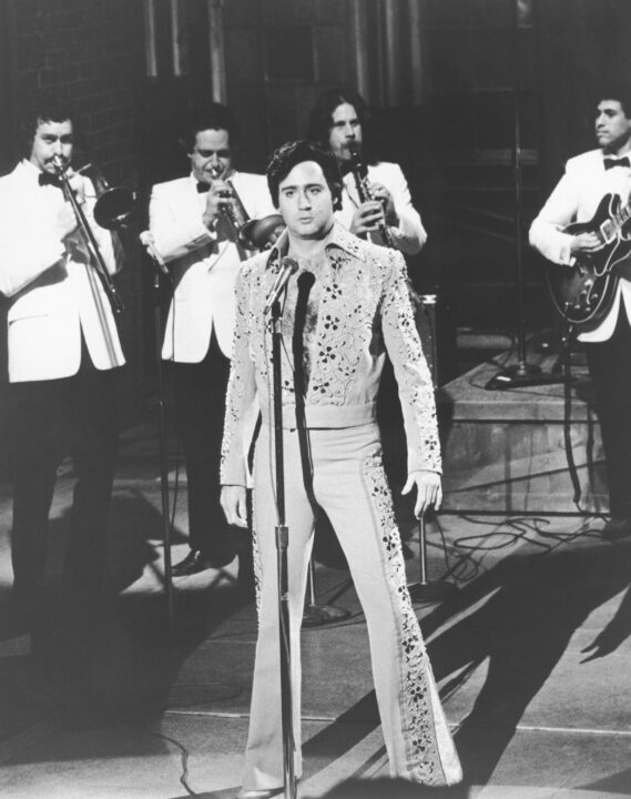 Andy Kaufman, impersonating Elvis Presley on SNL, with the Blues Brothers band (from left in back): Tom 'Bones' Malone, Alan Rubin, Blue Lou Marini, Danny Gottlieb, ca. 1970s