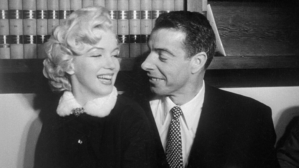 Marilyn Monroe and Joe DiMaggio, demonstrate that without rehearsal . This sequence of pictures were taken in the judge's chambers where they were married. You might call it the evolution of a wedding kiss. They smile happily.