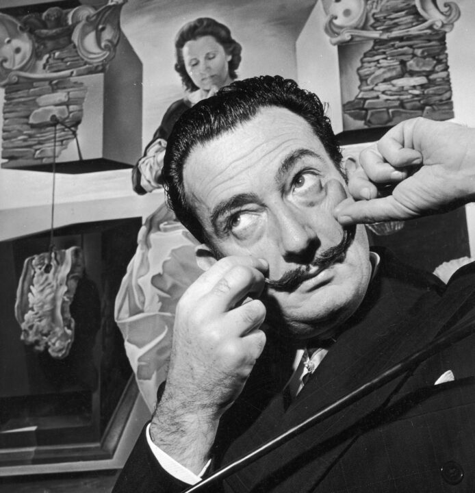Spanish surrealist artist Salvador Dali (1904 - 1989) in London with one of his paintings entitled 'The Madonna of Port Lligat', December 1951.