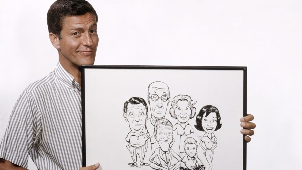 THE DICK VAN DYKE SHOW, Dick Van Dyke, with a caricature he did of cast members (from left) Morey Amsterdam, Richard Deacon, himself, Rose Marie, Larry Mathews, Mary Tyler Moore, 1964.