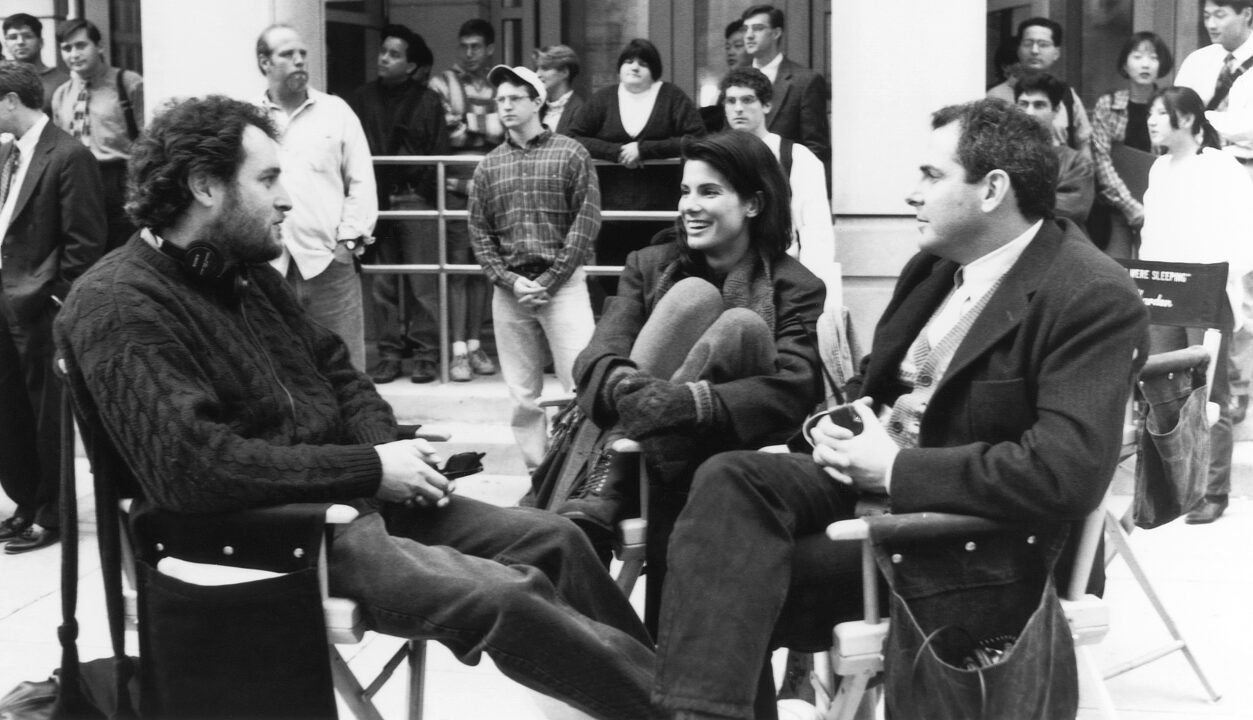 WHILE YOU WERE SLEEPING, from left: director Jon Turteltaub, Sandra Bullock, producer Roger Birnbaum, on set, 1995. ph: