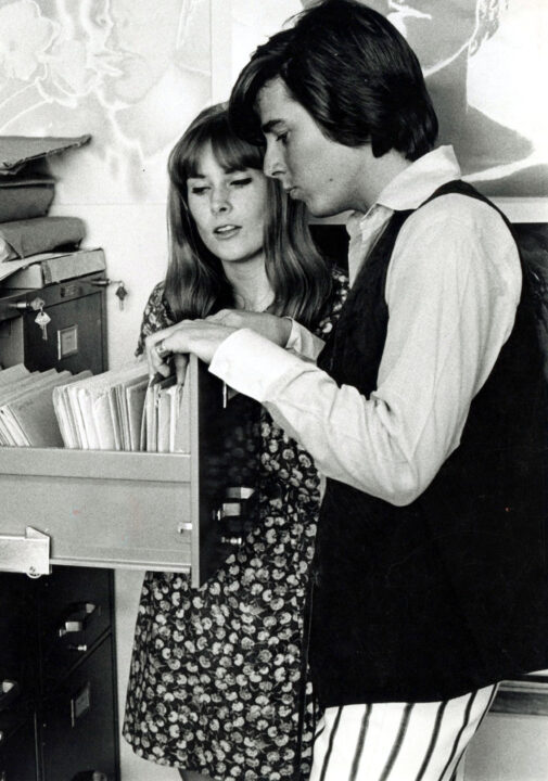 Ann Moses and Bobby Sherman look in a filing cabinet