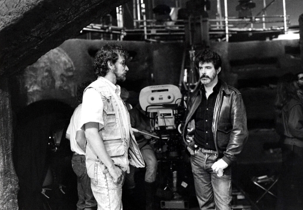Director Steven Spielberg, producer George Lucas on the set of INDIANA JONES AND THE TEMPLE OF DOOM, 1984, (c) Paramount/courtesy Everett Collection