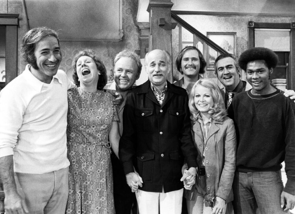 ALL IN THE FAMILY, from left: Jean Stapleton (second), Carroll O'Connor (third), Norman Lear (front, center), Rob Reiner (fifth), Sally Struthers (right of center), Mike Evans (right), (1970s), 1971-79.