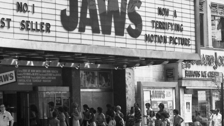 black and white image from 1975 of crowds lined up outside a movie theater to see