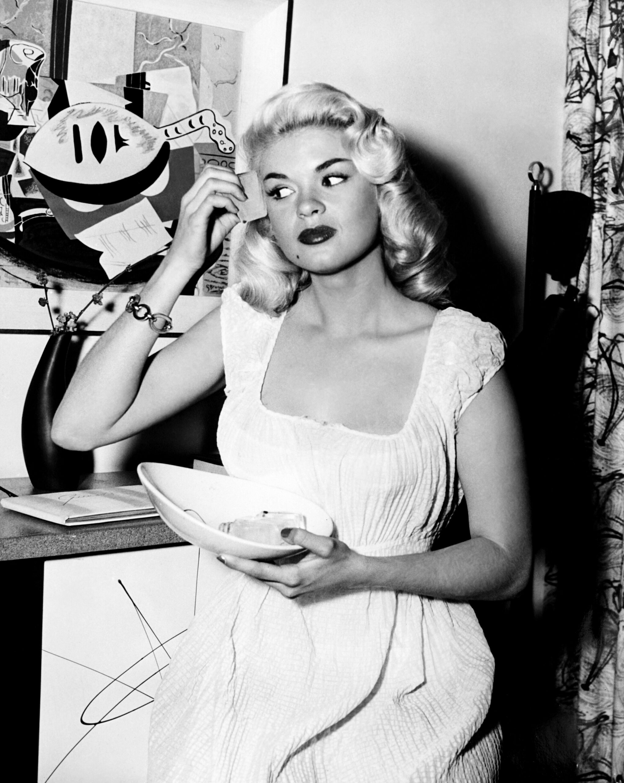 ILLEGAL, Jayne Mansfield applying makeup on-set, 1955