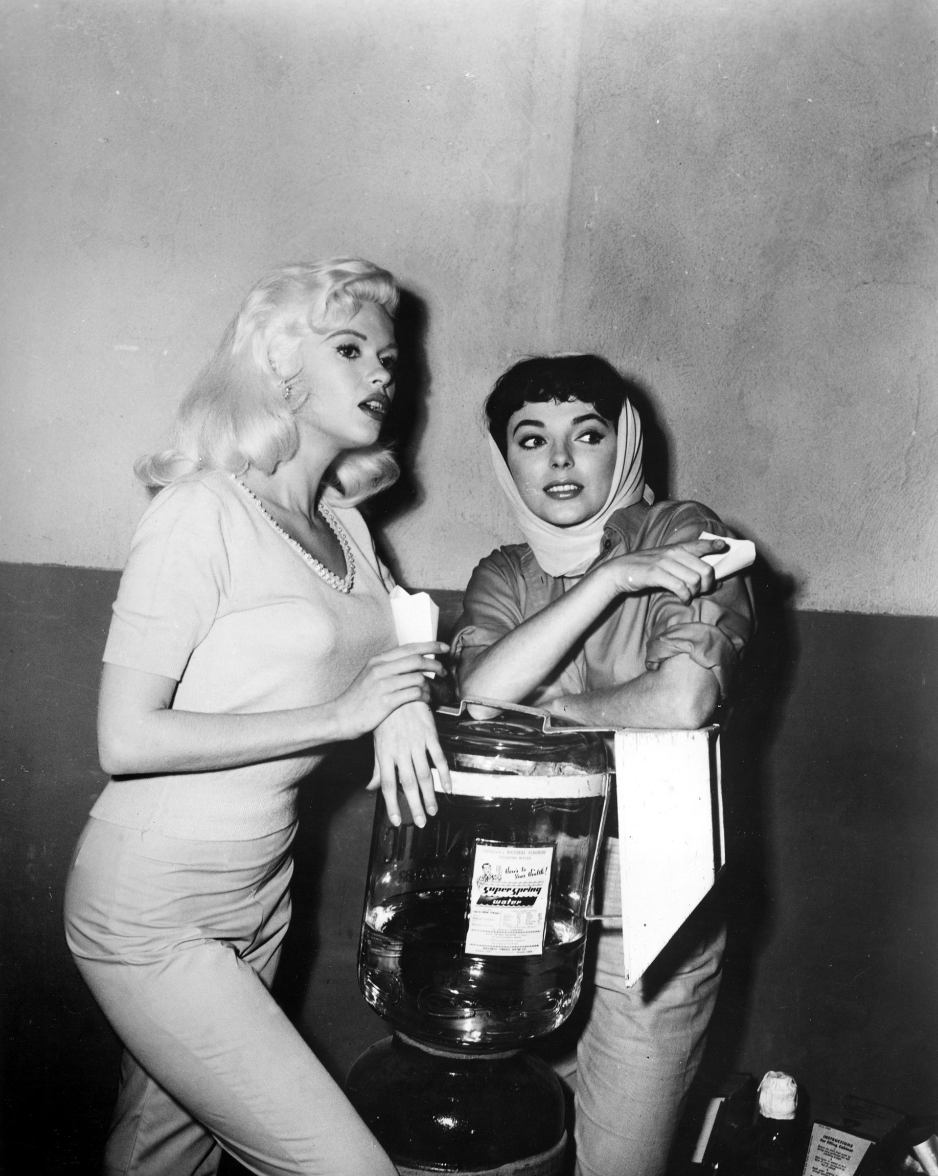 Jayne Mansfield and Joan Collins hanging out at the water cooler on the 20th Century Fox lot, publicizing THE WAYWARD BUS, 1957