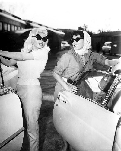 Jayne Mansfield and Joan Collins bidding each other good night after a hard day's work on the 20th Century Fox lot, publicizing THE WAYWARD BUS, 1957