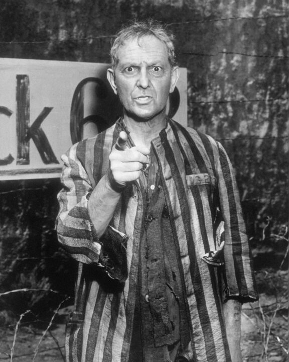Actor Joseph Schildkraut as the ghost of Alfred Becker, an inmate of Dachau concentration camp, in 'Deaths-Head Revisited ', an episode in the US TV series 'The Twilight Zone', 1961. He is dressed in the striped clothing worn by prisoners of the camp. He is angrily looking and pointing toward the camera (at the former commandant of the camp, unseen here).