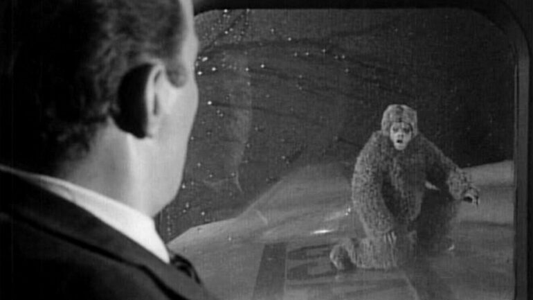 Airline passenger Bob Wilson, played by William Shatner, observes a gremlin, played by Nick Cravat, on the plane's wing. 'Nightmare At 20,000 Feet,' episode of The Twilight Zone. Initial television broadcast on October 11, 1963. Image is a frame grab.