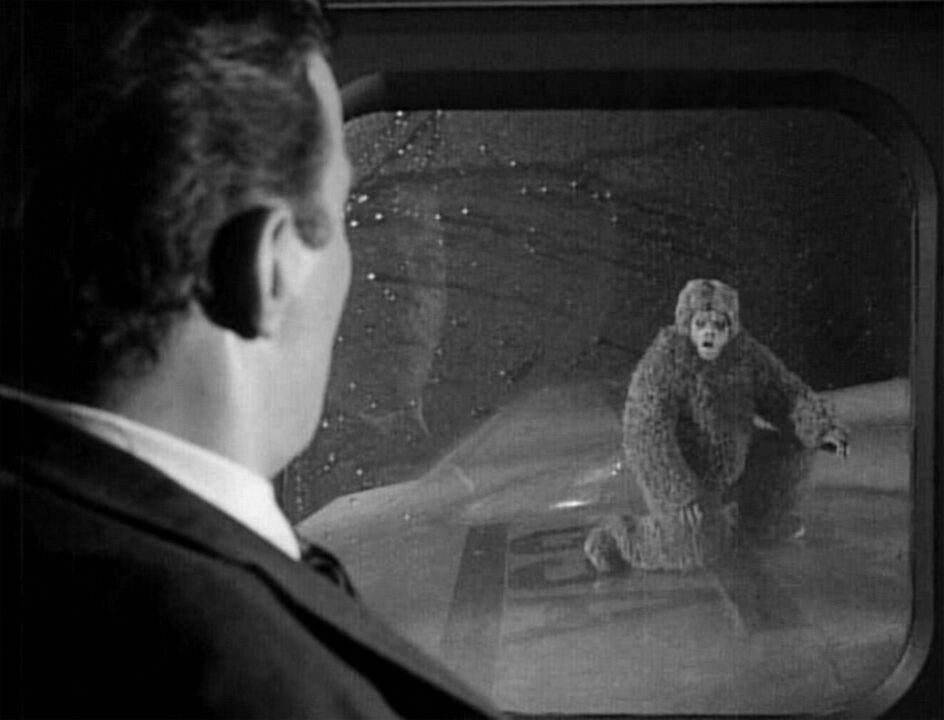 Airline passenger Bob Wilson, played by William Shatner, observes a gremlin, played by Nick Cravat, on the plane's wing. 'Nightmare At 20,000 Feet,' episode of The Twilight Zone. Initial television broadcast on October 11, 1963. Image is a frame grab.