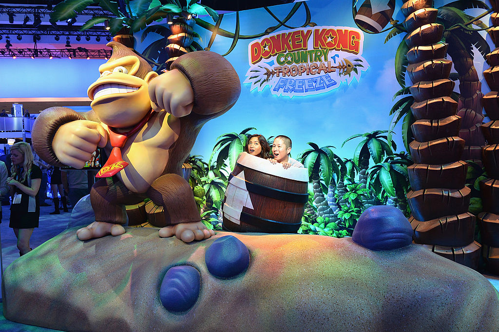 Fans enjoy the Nintendo Donkey Kong display at the E3 Gaming and Technology Conference at the Los Angeles Convention Center on June 11, 2013 in Los Angeles, California