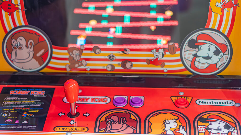 Red and yellow Donkey Kong arcade machine with animal heads illustration, two control buttons, circular logo, colorful graphics, indoors setting, possibly Nintendo o Kyiv, Ukraine - June 7, 2025