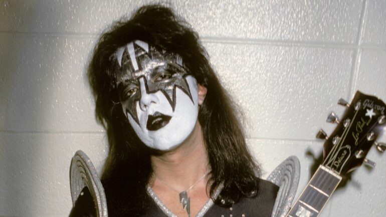 Ace Frehley of Kiss poses backstage holding a Gibson Les Paul guitar, United States, 1976.