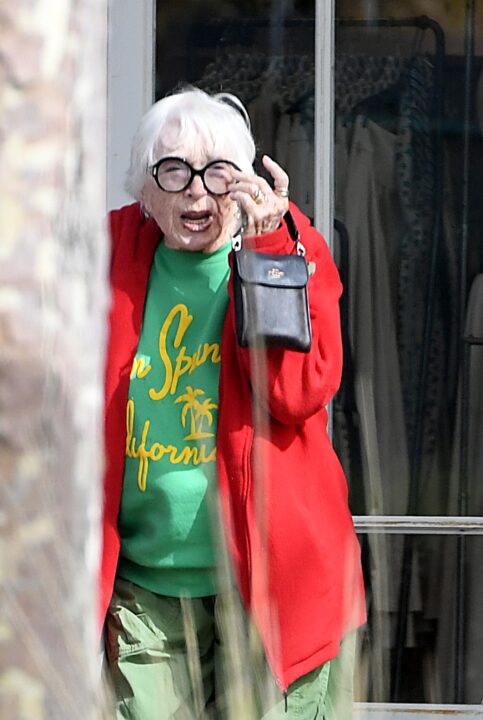 EXCLUSIVE. Coleman-RaynerMalibu, CA, USA. November 4, 2025 Shirley MacLaine, 91, nearly takes a tumble as she mis-steps whilst crossing a road in her Malibu neighborhood. The movie legend, who won a Best Actress Oscar in 1983 for her role in the family drama Terms of Endearment, was on her way to a fancy lunch at Lucky’s Steakhouse, an upscale eatery favored by celebrities including the Kardashians, on November 4, 2025. She wore a colorful outfit including green pants and matching colored sweater, a red overcoat and comfy slip-on shoes. Fortunately for Shirley she was holding onto the arm of a male friend when she slipped over, so she avoided a nasty fall. After dining for over an hour she brought two bags of food to go and popped into a local grocery store to grab several bouquets of flowers. CREDIT MUST READ: Jeff Rayner / Coleman-Rayner Tel US (001) 310-474-4343 – office www.coleman-rayner.com