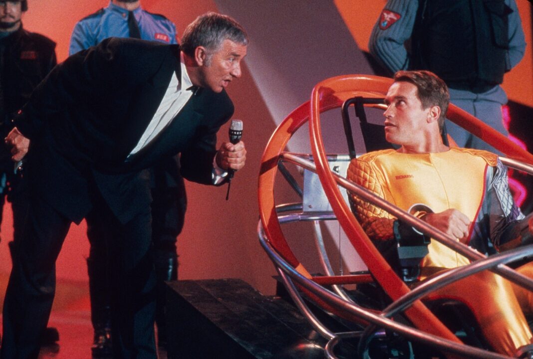 THE RUNNING MAN, from left, Richard Dawson, Arnold Schwarzenegger, 1987. © TriStar Pictures / courtesy Everett Collection