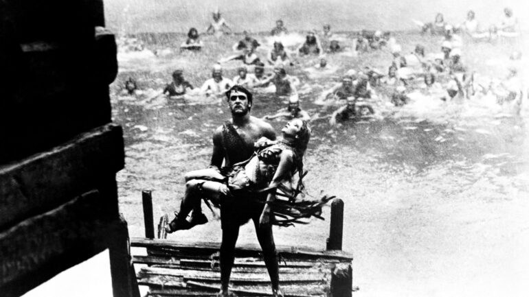 NOAH'S ARK, George O'Brien, carrying Dolores Costello, 1928