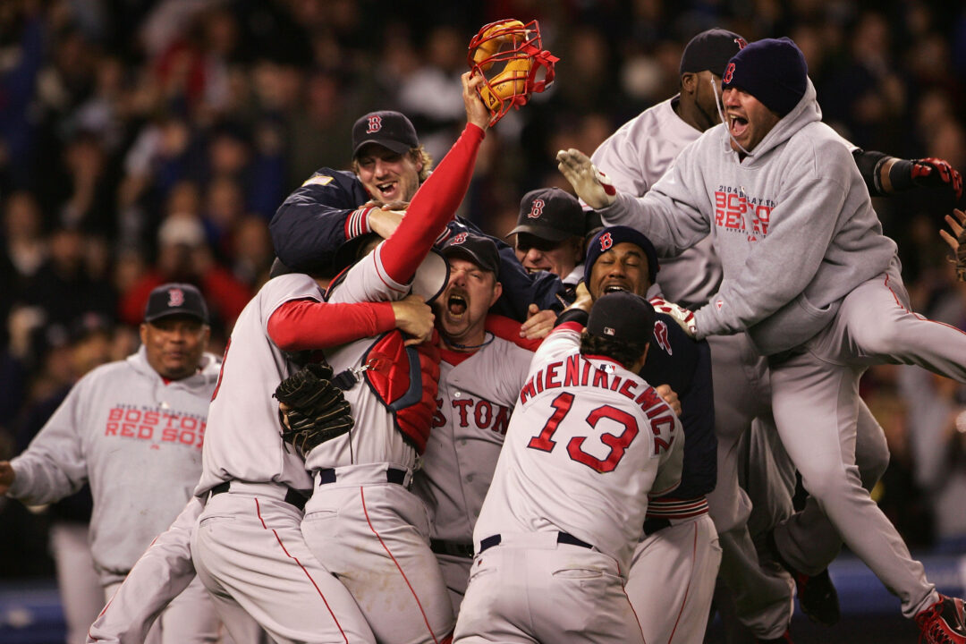 The Boston Red Sox celebrate after defeating the New York Yankees 10-3 in game seven of the American League Championship Series on October 20, 2004 at Yankee Stadium in the Bronx borough of New York City. 