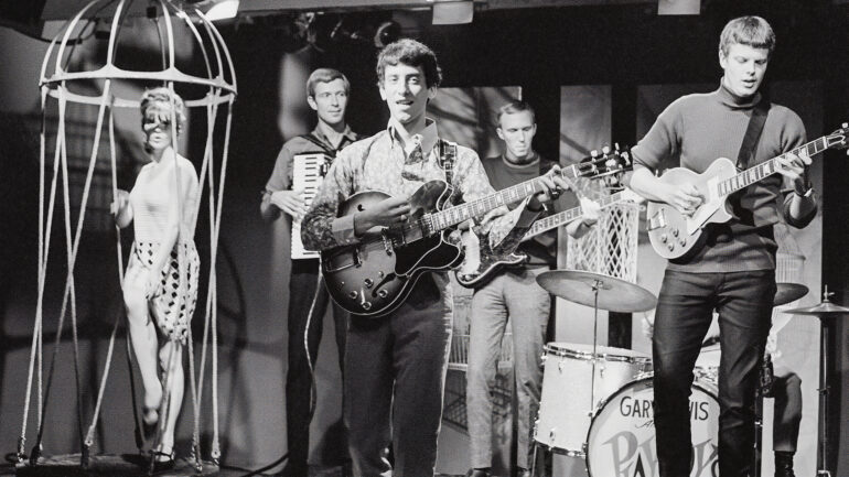 American rock and roll group Gary Lewis & the Playboys, performing with their new line-up, 1965. From left to right, John R. West on the Cordovox, lead singer Gary Lewis, and guitarists Carl Radle and Tom Tripplehorn. Tom Tripplehorn is playing a Gibson Les Paul Goldtop guitar.
