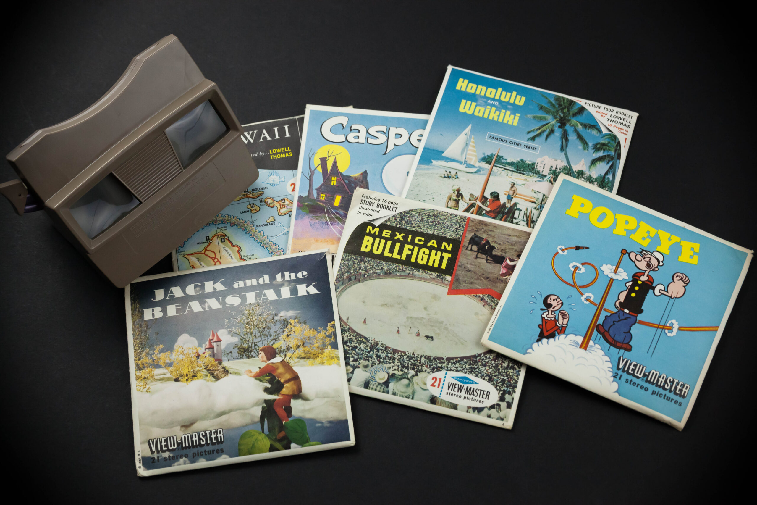 Vintage View Master reels with viewer on a black background