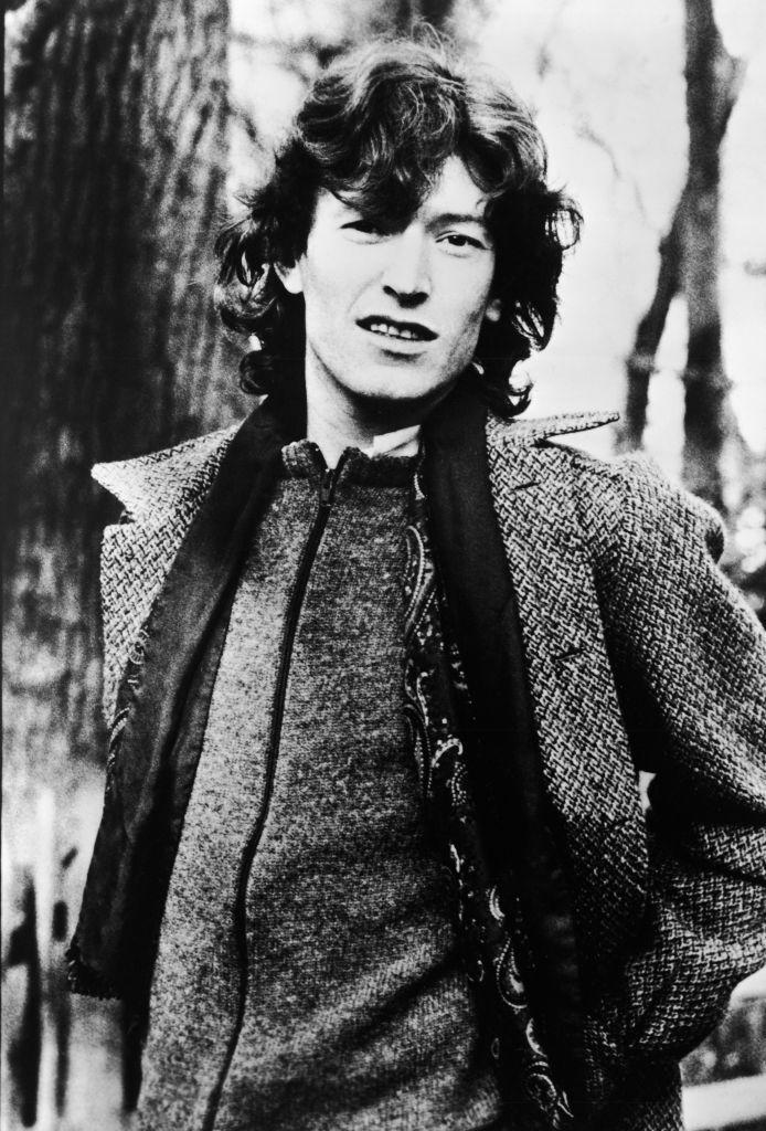 Promotional portrait of English pop musician Steve Winwood (of the group Traffic) as he stands outside, hands behind his back, 1980s