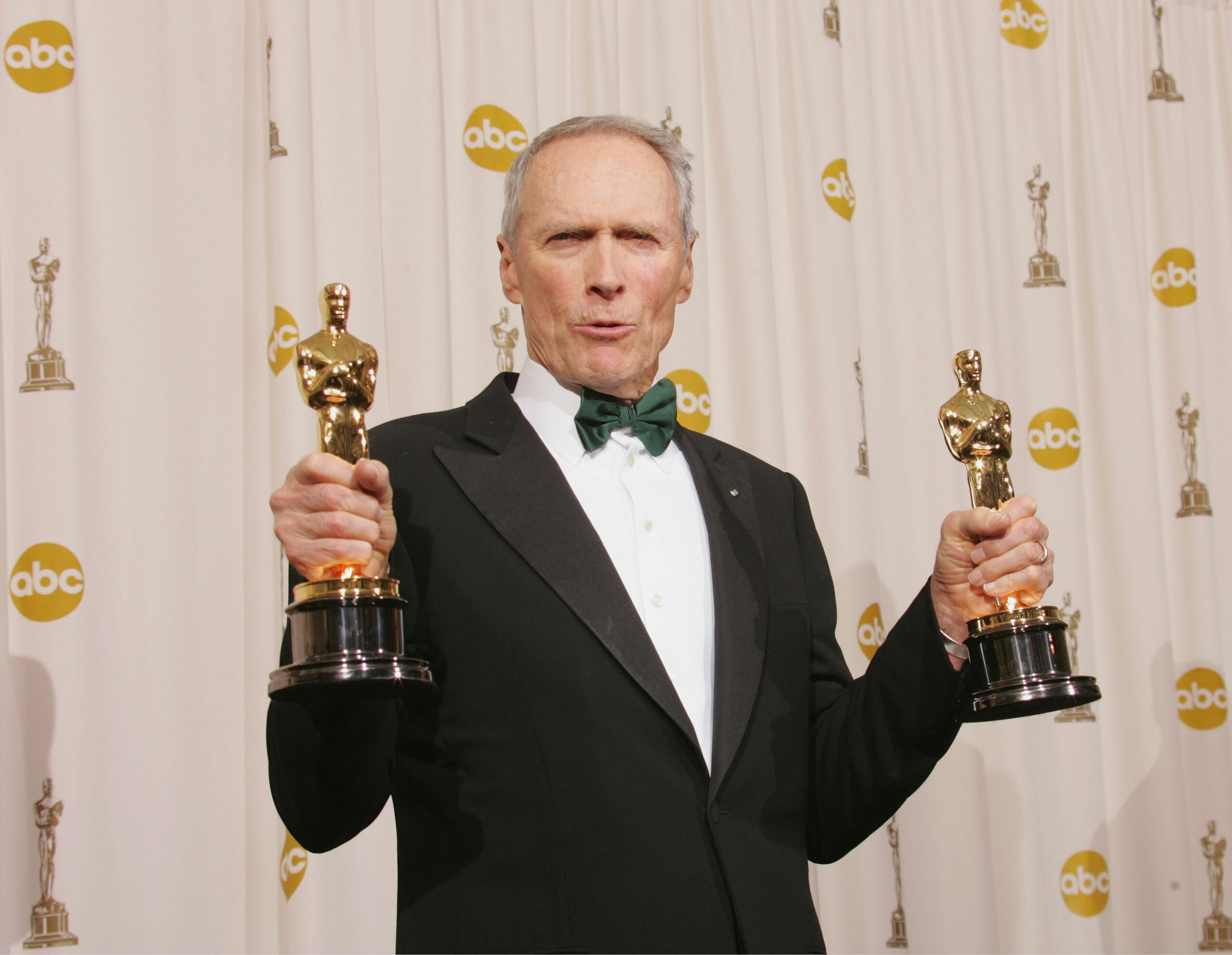 Producer Clint Eastwood poses with his awards for Best Motion Picture and Best Director for "Million Dollar Baby" backstage during the 77th Annual Academy Awards on February 27, 2005 at the Kodak Theater in Hollywood, California.