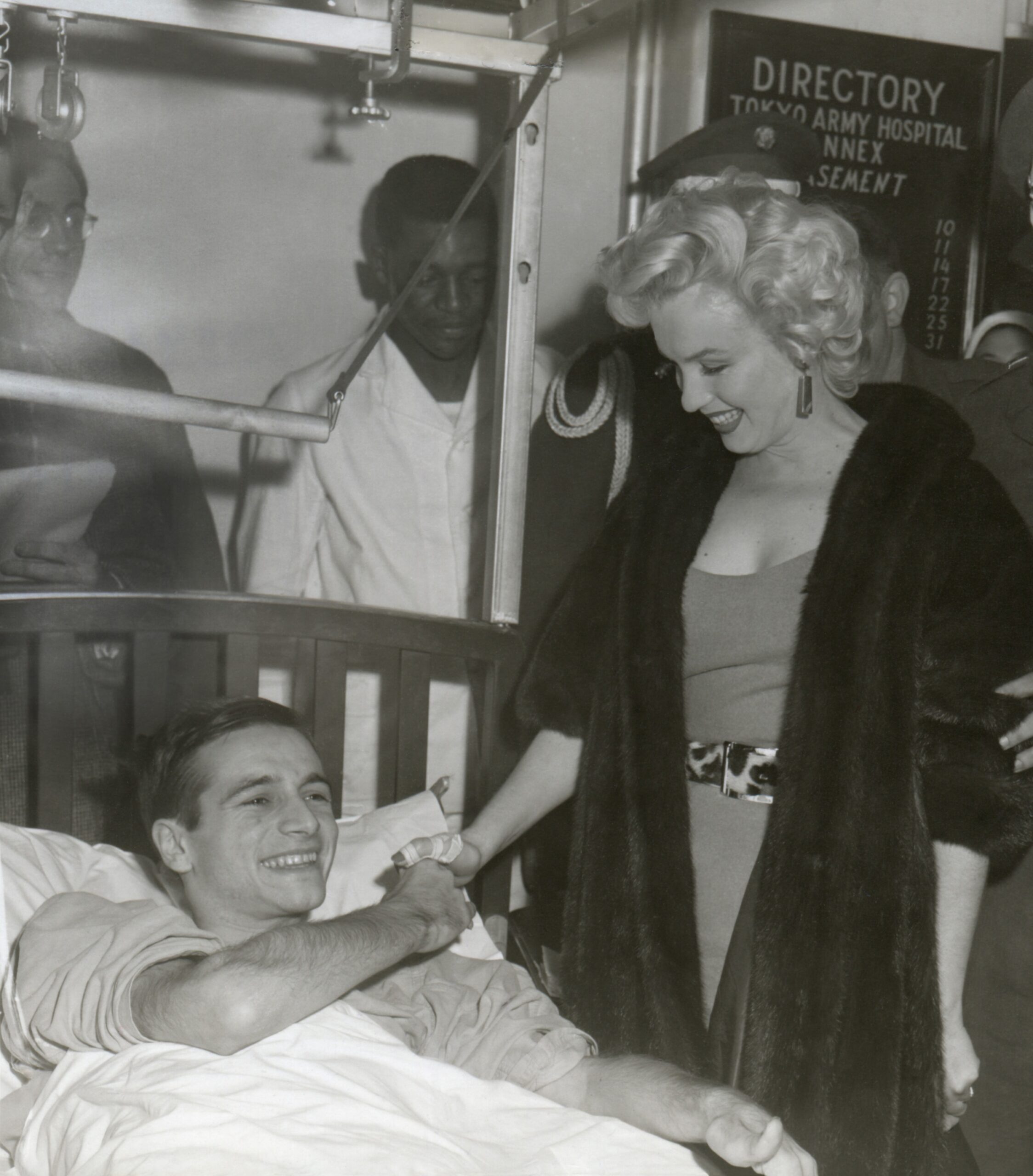 Marilyn Monroe visiting a wounded soldier in a hospital in Japan. Ca. Feb. 18-22, 1954. ()